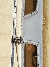 Close-up of metal chain against wall