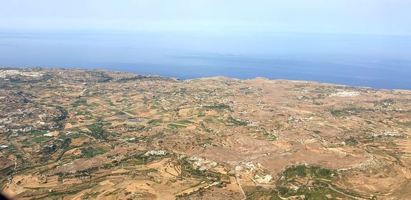 High angle view of sea and mountains against sky