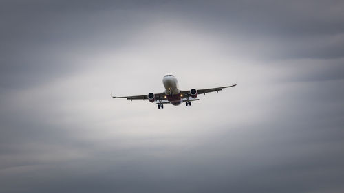 A plane in an overcast sky, preparing to land at the airport, city eindhoven, the netherlands