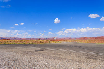 Road passing through landscape against sky