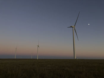 Twilight view of the moon on a wind farm