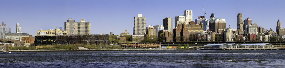 Modern buildings in city against clear sky