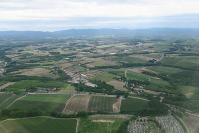 Aerial view of agricultural landscape against sky