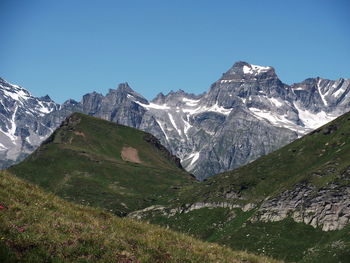 Scenic view of mountains against clear blue sky