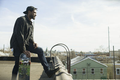 A young man on a roof.