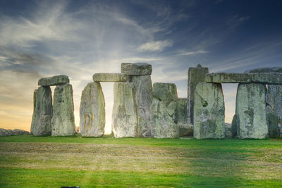 Panoramic view of stone structure on field against sky