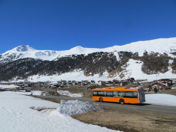 Scenic view of snow covered mountains against clear sky