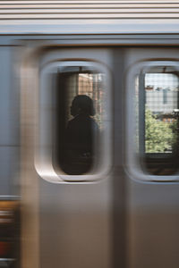 Reflection of train on glass window