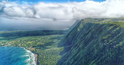 Aerial view of sea and mountain against sky