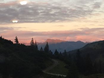 Scenic view of mountains against cloudy sky