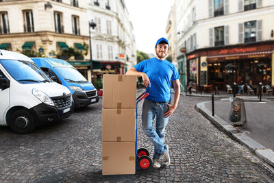 Portrait of man standing on street in city