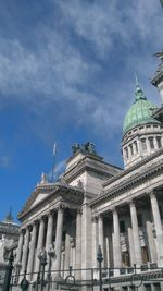 Low angle view of historical building against cloudy sky