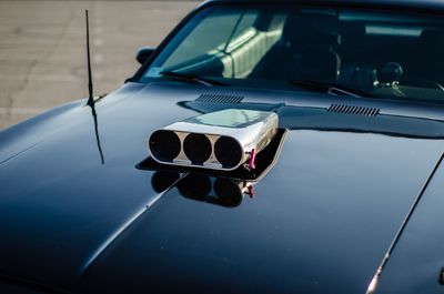 High angle view of charger on car hood