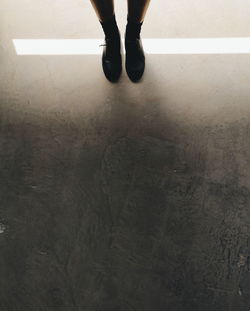 Low section of woman standing on floor