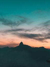 Scenic view of silhouette mountains against sky at sunset