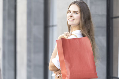 Portrait of a smiling young woman standing outdoors