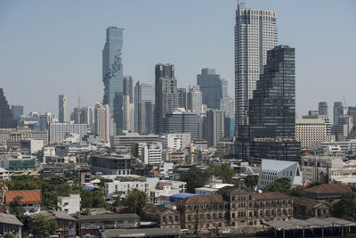Modern buildings in city against clear sky