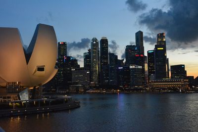 Artscience museum at marina bay sands against sky in dusk