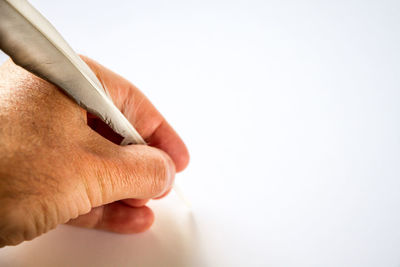 Close-up of person hand over white background