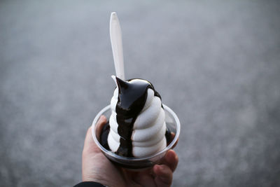 A hot fudge sundae in a plastic cup