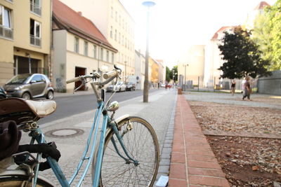 Bicycle parked on road in city