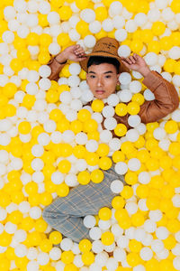 High angle portrait of man lying in ball pool