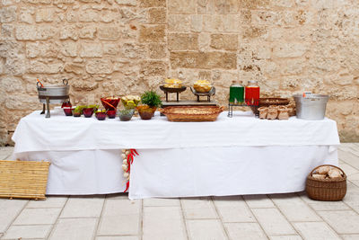 Rural reception table served with various food and drinks for birthday party or wedding