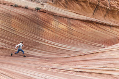A young woman runner enjoys a shakeout run among the famous wave
