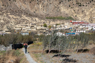 People walking on road amidst buildings in city