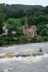 Dee river by english methodist church against trees