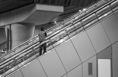 Low angle view of illuminated escalator in building