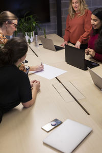 Female coworkers having meeting in boardroom