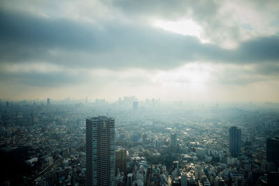 High angle view of city buildings against sky