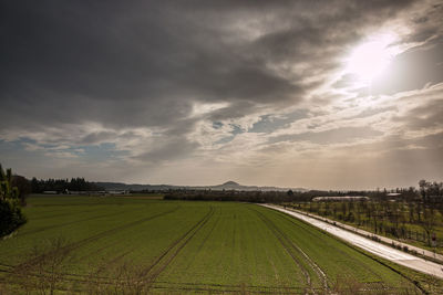 Scenic view of agricultural field against sky during sunset