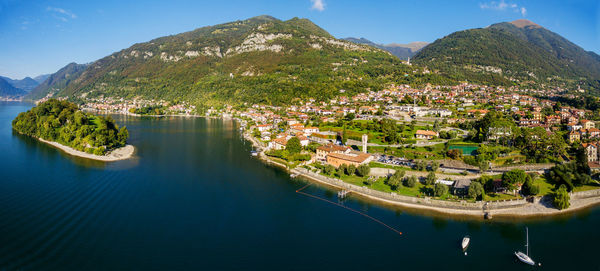 Aerial view of town by bay against sky