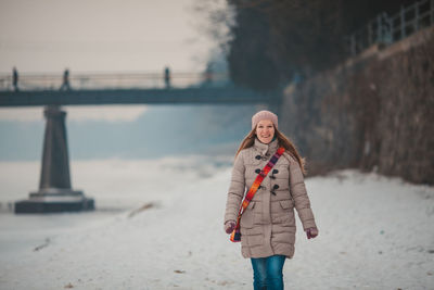 Woman standing on snow covered landscape during winter