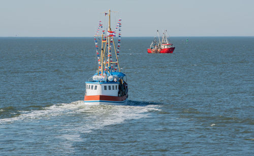 Nautical vessel on sea against clear sky