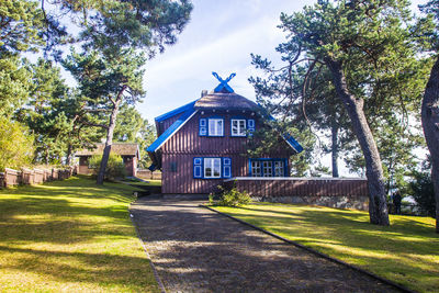 House by trees against sky