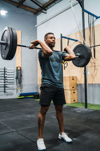 Full length of man exercising in gym