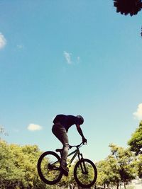 Bicycle parked against blue sky