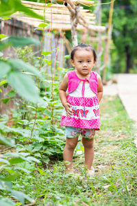 Portrait of a girl standing against plants