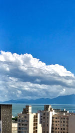 View of cityscape against blue sky