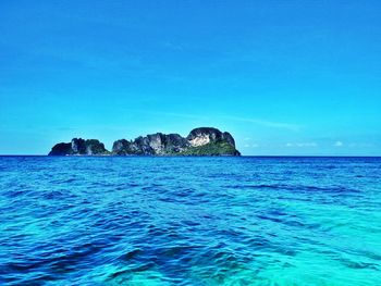 Scenic view of sea against blue sky