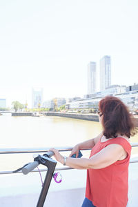 Rear view of woman sitting on city