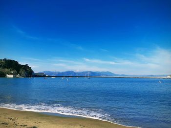 Scenic view of sea against blue sky