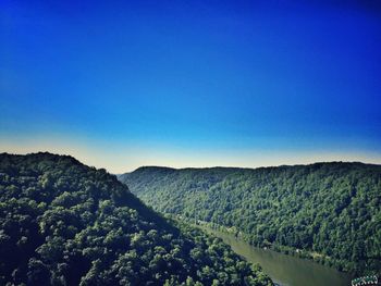 Scenic view of mountains against clear blue sky