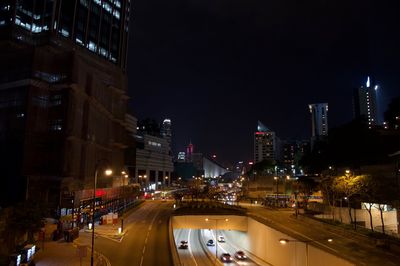 Traffic on city street and buildings at night