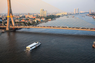 High angle view of city by river against sky