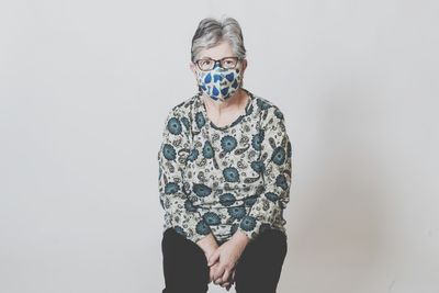 Portrait of mid adult man standing against white background