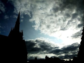 Low angle view of silhouette buildings against sky at dusk